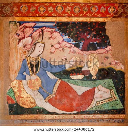 ISFAHAN, IRAN - OCT 17: Eastern woman drinking tea in the garden of the fresco of palace Chehel Sotoun on October 17, 2014. Safavid era 