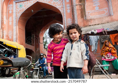 JAIPUR, INDIA - JAN 25: Unidentified children play outdoor on the full of traffic street in Pink City on January 25, 2015. Jaipur, with population 6,664000 people, is a capital of Rajasthan