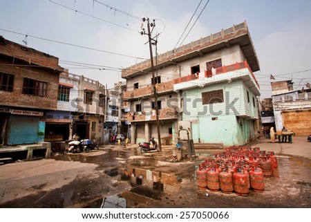 JAIPUR, INDIA - JAN 25: Gas cylinders put on a dirty street with old houses of poor families on January 25, 2015. Jaipur, with population 6,664000 people, is a capital of Rajasthan