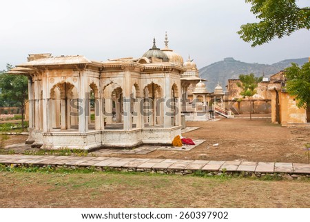 JAIPUR, INDIA - JAN 24: Indian women sleep near the Gaitore Cenotaphs with typical Rajasthani Carvings wall on January 24, 2015. Jaipur, with population 6,664,000 people, is a capital of Rajasthan