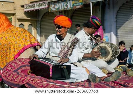 JAISALMER, INDIA - MAR 1: Musicians in turbans and glasses play music on the performance of the Desert Festival on March 1, 2015 in India. Every winter Jaisalmer takes the famous Desert Festival