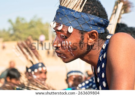 JAISALMER, INDIA - MAR 1: Portrait of young african man with painted face in tribal tradition on the Desert Festival on March 1, 2015 in Rajasthan. Every winter Jaisalmer takes the big Desert Festival