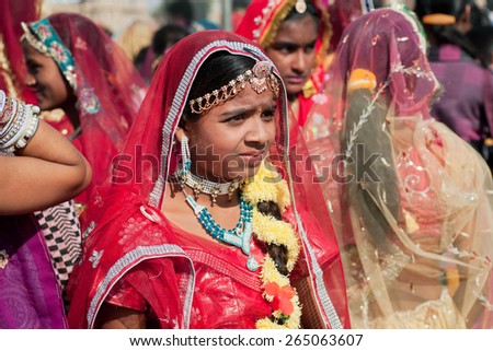 JAISALMER, INDIA - MAR 1: Cute woman looking the friends in the crowd of indian ladies during the Desert Festival on March 1, 2015. Every winter Jaisalmer takes Desert Festival of Rajasthan