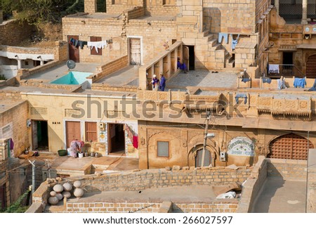 JAISALMER, INDIA - MAR 1: Grunge stone houses in poor area of historical indian town on March 1, 2015. Jaisalmer lies in the heart of the Thar Desert and has a population of about 78,000.