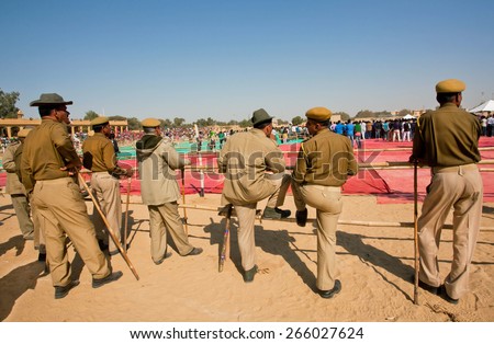 JAISALMER, INDIA - MAR 1: Group of police men keep order on the popular indian events of Desert Festival on March 1 2015 in Rajasthan. Every winter Jaisalmer takes the Desert Festival