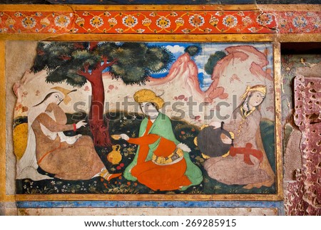 ISFAHAN, IRAN - OCT 17: Old murals of palace Chehel Sotoun with picture of persian couple and musician in garden on October 17, 2014. Safavid era 