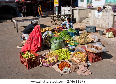 PUSHKAR, INDIA - FEB 10: Vegetable market on the sunny street of indian city on Fabruary 10, 2015. With population of 15,000, Pushkar is a popular touristic town in Ajmer district