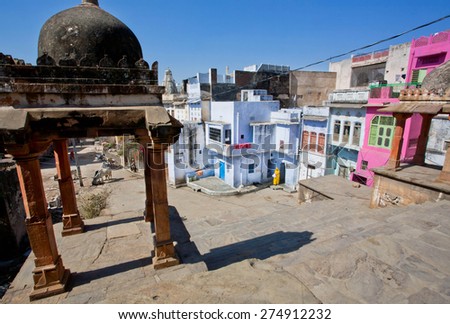 PUSHKAR, INDIA - FEB 9: Woman goes past colorful houses in historical area of indian city on February 9, 2015. With population of 15,000 people, Pushkar is a popular touristic town in Ajmer district
