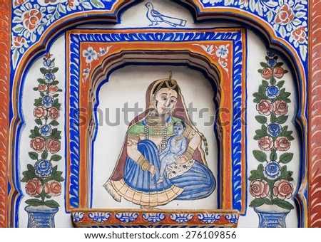 NAWALGARH, INDIA - FEB 6: Mother and baby Krishna in flowers on the old Havelis mansion fresco on February 6, 2015. With population of 100,000, Nawalgarh is the education center of Shekhawati region
