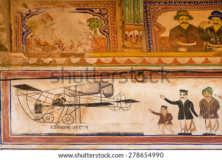 MANDAWA, INDIA - FEB 7: People happy to see the first flying machine on fresco in Shekhawati art style on February 7, 2015. With pop. of 21000, Mandawa is touristic site with naive art Haveli mansions