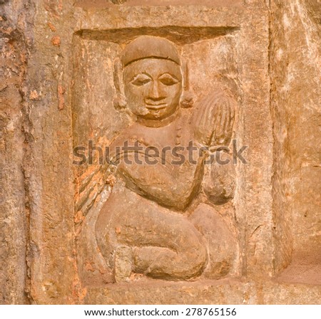 BUNDI, INDIA - FEB 17: Stone bas-relief with woman clasped her hands together in prayer on February 17, 2015 in Rajasthan. Bundi is a city with 105,000 inhabitants on the northwest India