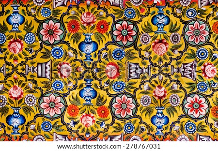 Floral patterns on colorful mural of historical mansion in Rajasthan, India