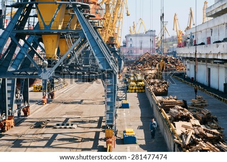 ODESSA, UKRAINE - APR 12: Cargo cranes on rails and cargo warehouses in the seaport on April 12, 2015. Port of Odessa is the largest Ukrainian seaport with annual traffic capacity of 40 million tonnes