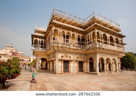 JAIPUR, INDIA - JAN 24: Woman in sari walking past fantastic building of Mubarak Mahal, built in 19th century in City Palace on January 24, 2015. Jaipur with popul. 6,664000, is a capital of Rajasthan