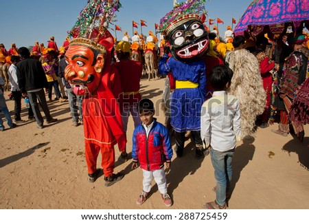 JAISALMER, INDIA - Feb 1: Unidentified children in carnival crowd with scary evil characters of Hinduism on the Desert Festival on February 1, 2015. Every winter Jaisalmer takes famous Desert Festival