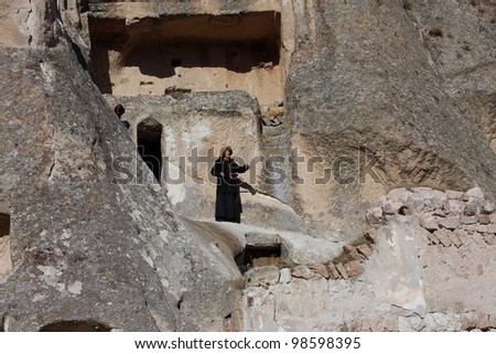 UCHISAR, TURKEY - JANUARY 4; Woman who has lived in the cave home of Cappadocia on Jan 4, 2012, in Turkey. The first populations of Cappadocia were Hatties, Luvies and Hittites near the 3000 B.C.