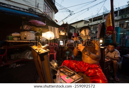 Bangkok, Thailand - January 17th, 2015: A Chinese opera performer dressing in front of a mirror before the show in backstage of a traditional Chinese opera on January 17, 2015 in Bangkok, Thailand.