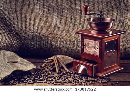 hot cup of coffee and fresh coffee beans and coffee grinder