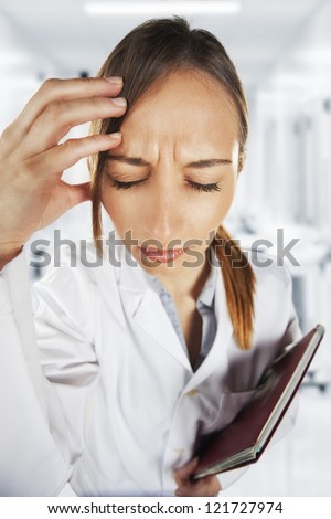 Medical woman with headache at hospital / Stress woman young doctor