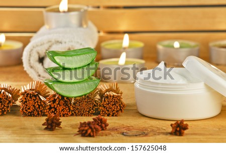 Aloe vera plant for skincare therapy./ Fresh aloe vera slices on wooden with some candles.