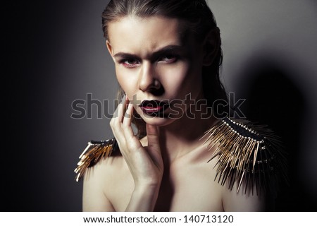 Sexy strict woman with red lips and epaulettes over dark background