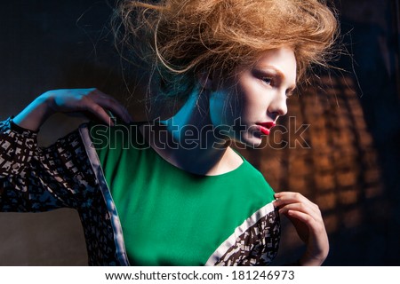 portrait of fashion women in green dress and with red lips abstract dark background