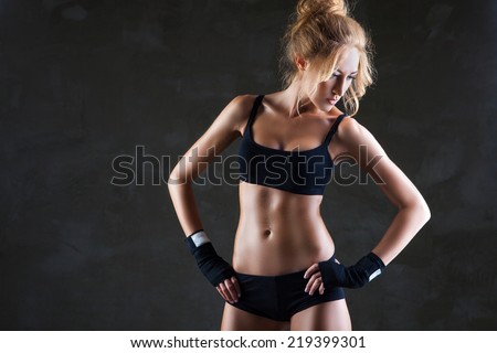 Healthy lifestyle and extreme sports. Beautiful fit woman model in black hand bandage