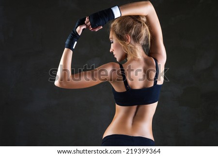 Healthy lifestyle and extreme sports. Beautiful fit woman model in black hand bandage