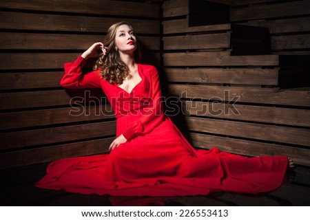 https://image.shutterstock.com/display_pic_with_logo/808756/226553413/stock-photo-portrait-of-beautiful-sensual-woman-in-long-fashion-red-dress-sitting-on-floor-over-wooden-226553413.jpg