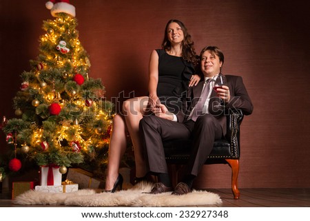Christmas Couple. Happy Smiling Family at home celebrating New Year