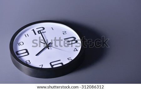 Round office clock shows at 8 o\'clock with copy space or Clock abstract background.