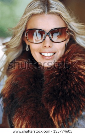 Outdoor portrait of a beautiful woman face in sunglasses - close up