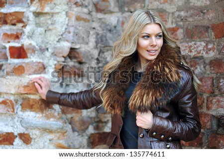 Portrait of a beautiful girl posing near a wall - portrait