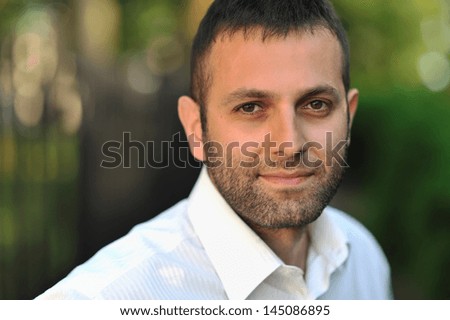 Portrait of young handsome man face outdoors