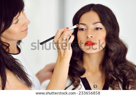 Young beautiful asian woman applying make-up by make-up artist Foto stock © 