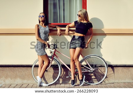 Girls with bike. Outdoor fashion portrait