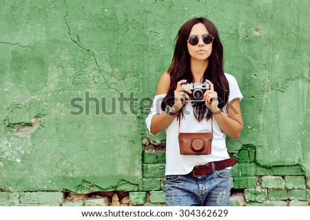 Beautiful woman with old camera