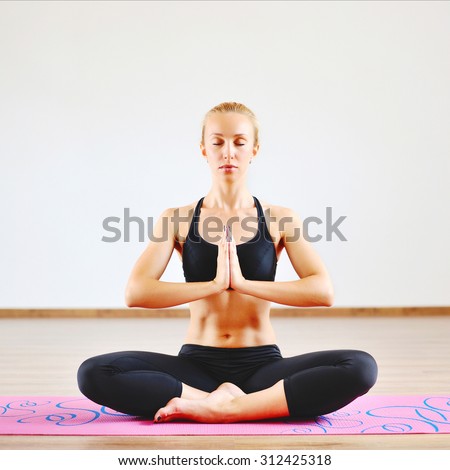 Young beautiful woman in the prayer position with eyes closed