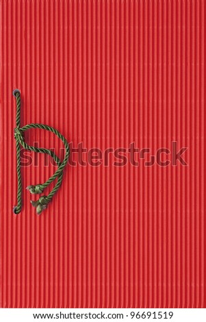 Red paper notebook cover bound with green cord