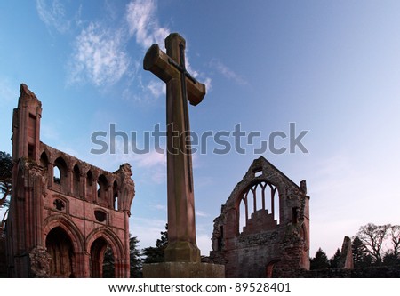 The ruins of Dryburgh abbey and cross at Sunset