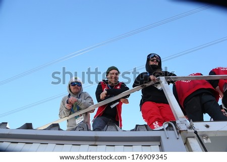 SOCHI, RUSSIA- February 13th:  (LR) Coach Luke Allen, Justin Dorey and Peter Adam crook watch the ski slopestyle event on February 13th 2014 in Sochi Russia.