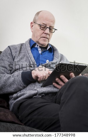 Older man using tablet pc
