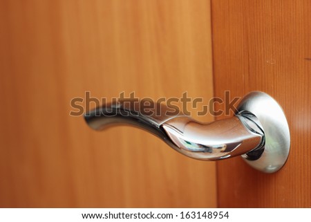 Metal handle on the wooden door
