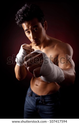 Boxer street fighter asian six-pack on Black Background