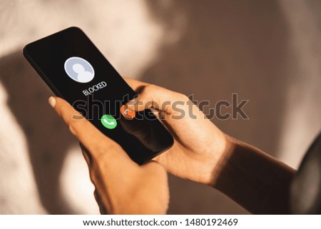 Woman Block a Phone Number or incoming Call from a anonymous stalker or Ex boyfriend. Stalking or bullying with phone concept. Stalker caller, scammer or stranger. Woman blocking incoming call. Stock foto © 