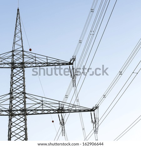 Electricity pylon close-up power pole high voltage against blue sky