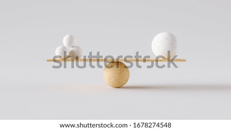 wooden scale balancing one big ball and four small ones. Concept of harmony and balance