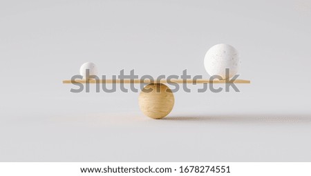 wooden scale balancing one big ball and one small ball. Concept of harmony and balance