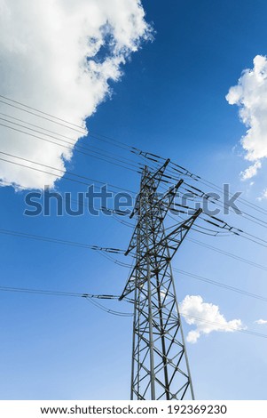 electricity Pylon on blue cloudy sky