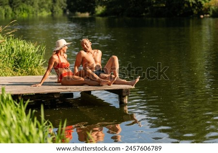 Similar – Image, Stock Photo Mature couple swimming together in fresh water